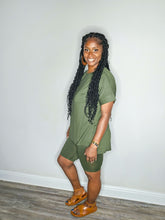 Load image into Gallery viewer, Woman wearing a dark olive 2 piece set standing against a white wall.