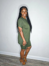 Load image into Gallery viewer, Woman wearing a dark olive 2 piece set standing against a white wall.
