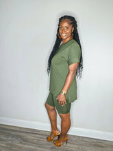 Load image into Gallery viewer, Woman wearing a dark olive 2 piece set standing against a white wall.